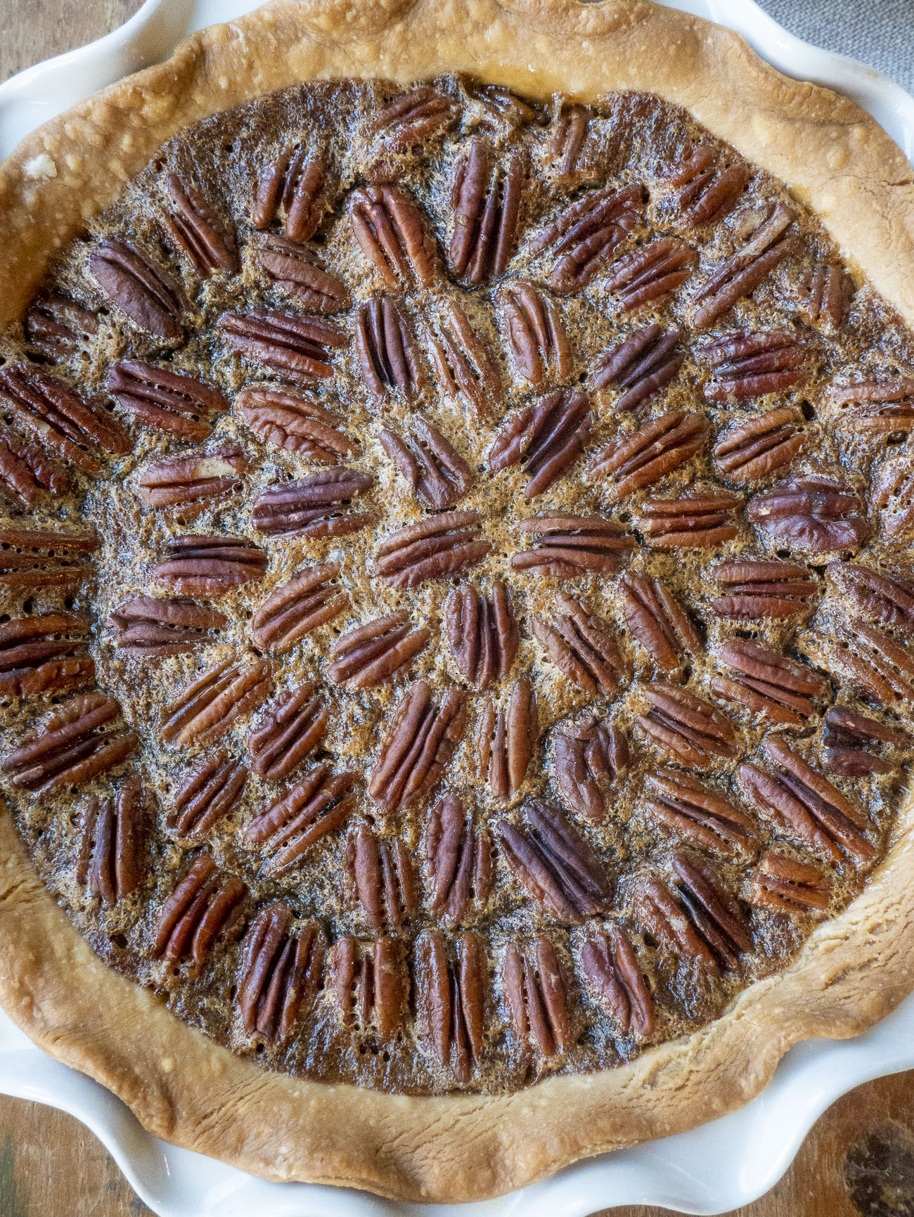 Recipe Tin Project: Kentucky Pecan Pie A classic pie from an old recipe card.  Kristy Norrell by1 Kristy Norrell hearts When you share or print a 12 Tomatoes recipe, you’re making mealtime meaningful. 100% of the Share to Care sponsor fees fund meals for families in need. Learn More  Pecan Pie is as classic as pie gets, so when I saw this old recipe card I knew I had to make it. And besides, this wasn’t just any Pecan Pie, this was Kentucky Pecan Pie, which seemed even more enticing. As far as I’m concerned, pie is at its best when it’s nostalgic and that’s just what this pie is. And only seven ingredients? Count me in.    This recipe card came to me through the Recipe Tin Project, a project where I cook my way through an old recipe tin full of vintage recipes. But you might have already guessed that. It’s chock full of old recipe cards, most of which seem to be from the ’60s and ’70s. I love food history, and the idea is to breathe new life into these recipes from the past and maybe learn a technique or two from them along the way. The recipes come from different people with different handwriting; some have sweet illustrations while others are on plain (often smudged and stained) index cards.   This card has a sweet little illustration in the top left corner with a steaming kettle and a few veggies in primary colors. It doesn’t say who the recipe is from but it’s written in blue ink in a cursive that’s straight up and down and easy to read. The ingredients are listed on the right, the directions on the left, which is also very easy to read. (Not all these cards are.)   There’s no pastry crust recipe, so you can use your favorite, or a storebought shell if you’re looking to save some time. (I was and so I did.) The card tells you quite simply to just combine the first ingredients and mix well, which is the corn syrup, dark brown sugar, salt, butter (or margarine), vanilla, and eggs (beaten). I used butter and after consulting some other pecan pie recipes, I figured that it was meant to be melted. After all, even softened butter wouldn’t mix well into the rest of the liquidy list.   You pour that into an unbaked pie crust…   And then you top it with a heaping cup of pecans. It tells you to sprinkle them over the top, but I got a little neater with it.  And then you bake.   The card says forty-five minutes but I probably could’ve gone a little bit longer, to be honest. This was ooey-gooey stuff. Pecan Pie is nearly always sticky and ooey-gooey, I guess, but this could’ve set a little bit more.    I don’t know what’s Kentuckian about this pie, but I will say that I liked it better than a lot of other pecan pies out there. While I often find them cloying, this one had a simple straightforward flavor that let the nuttiness of the pecans shine more than the sugar. This is one to keep coming back to!   Recipe Tin Project: Kentucky Pecan Pie Yield(s): Yield 1 pie  15m prep time  45m cook time  4.8 Rated by 11 reviewers hearts When you share or print a 12 Tomatoes recipe, you’re making mealtime meaningful. 100% of the Share to Care sponsor fees fund meals for families in need. Learn More Ingredients 1 cup white corn syrup 1 cup dark brown sugar 1/3 teaspoon salt 1/3 cup butter or margarine 1 teaspoon vanilla 3 whole eggs 1 heaping cup pecans 1 unbaked 9-inch pie shell  Preparation Preheat oven to 350°F. Stir together corn syrup, brown sugar, salt, and melted butter, and vanilla, and mix well. Add slightly beaten eggs and mix once more. Pour into unbaked pie shell. Sprinkle pecans over the top. Bake 45 minutes. Once cool top with whipped cream.    Around the Web How Long Should I Keep My Car? How Long Should I Keep My Car? Why Google Workspace for Business is Worth the Upgrade Why Google Workspace for Business is Worth the Upgrade The Close Relationship Between Stress and Sleep The Close Relationship Between Stress and Sleep Four Ways Food Banks Are Feeding Kids Right Now Four Ways Food Banks Are Feeding Kids Right Now Get Dog Food Designed for Your Dog’s Health & Happiness Get Dog Food Designed for Your Dog’s Health & Happiness Five Destinations to Explore During Hispanic Heritage Month Five Destinations to Explore During Hispanic Heritage Month Got Plant Milk? Add These 16 Plant Milks to Your Mug for Health, Flavor, and Fro Got Plant Milk? Add These 16 Plant Milks to Your Mug for Health, Flavor, and Fro Take on a Challenge: Make Pasta Al Limone at Home Take on a Challenge: Make Pasta Al Limone at Home The Best Places to Buy College Apparel Make Showing College Pride Too Easy The Best Places to Buy College Apparel Make Showing College Pride Too Easy   Cookie Salad Hori-07Classic Cookie Salad 3-Cheese Meatloaf3-Cheese Meatloaf Kentucky Hot Brown SlidersKentucky Hot Brown Sliders Braised Broccoli and BeansBraised Broccoli and Beans Strawberry Avocado SaladStrawberry Avocado Salad Copycat Pillsbury Cinnamon Roll Icing Korean Honey Butter Potatoes Colonial Vegetable Pottage Cauliflower Paneer FrittersCauliflower Paneer Fritters Iowa Party Bites Hori-09Iowa Party Bites Pumpkin Oreo Pie Icelandic Pylsa Tomato Soup