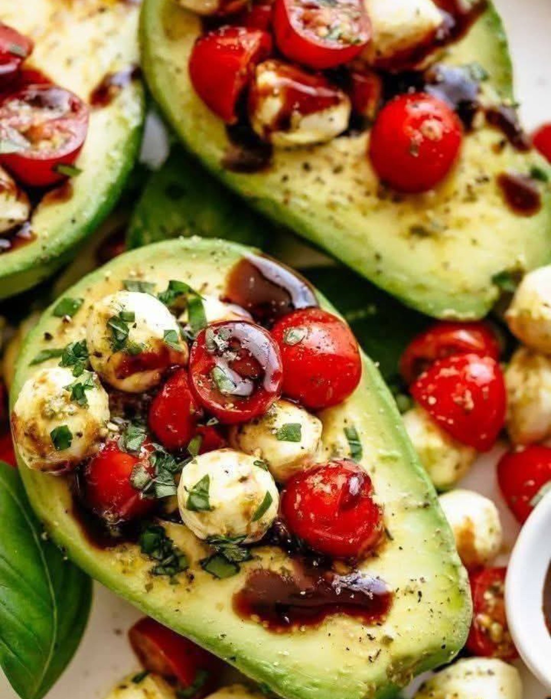 Basil pesto CAPRESE STUFFED AVOCADO drizzled