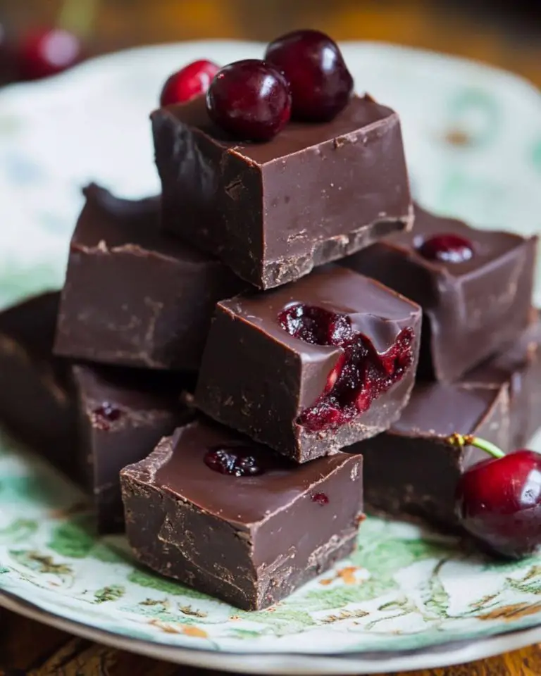 Decadent Cherry Chocolate Fudge: A Perfect Holiday Treat Ingredients For the Fudge Base 500g (17.6 oz) semi-sweet chocolate (55% cocoa solids), broken into small pieces 397g (14 oz) sweetened condensed milk 200g (7 oz) glacé cherries, chopped (plus 8 additional cherries for topping) 2.5 ml (½ tsp) almond extract Instructions Preparation Line a 20cm x 20cm (8-inch x 8-inch) baking tin with non-stick parchment paper, ensuring paper extends up the sides Chop glacé cherries, setting aside 8 pieces for decoration Break chocolate into small, uniform pieces for even melting Making the Fudge Create a double boiler by placing a heatproof bowl over a pan of simmering water, ensuring the bowl doesn’t touch the water Combine chocolate, condensed milk, almond extract, and chopped cherries (except reserved pieces) in the bowl Stir continuously until chocolate melts completely and mixture becomes smooth Pour mixture immediately into prepared tin Smooth surface with an offset spatula for a professional finish Decorate with reserved cherry pieces, pressing them lightly into the surface Refrigerate for minimum 2 hours until completely set Timing and Nutritional Information Prep Time: 15 minutes Cooking Time: 10 minutes Setting Time: 2 hours Total Time: 2 hours 25 minutes Yield: 36 pieces Per Piece (approximately):  Calories: 125 Protein: 1.5g Fat: 6g Carbohydrates: 16g Sugar: 14g Tips and Tricks Chop chocolate into uniform pieces for even melting Maintain water at a gentle simmer, not a rolling boil Use room temperature condensed milk for smoother blending Work quickly once chocolate is melted as mixture begins setting immediately Use a sharp knife dipped in hot water between cuts for clean edges Pat cherries dry before adding to prevent water content from affecting texture Variations and Substitutions Dark chocolate (70% cocoa) for a more intense flavor Milk chocolate for a sweeter version Dried cherries instead of glacé for less sweetness Kirsch liqueur (1 tablespoon) instead of almond extract Add 100g chopped nuts for additional texture White chocolate drizzle over the top for decoration Common FAQs Q: Why did my fudge turn grainy? A: This usually occurs from overheating. Maintain gentle heat and constant stirring for smooth results.   Oatmeal and Pumpkin Seed Bread Recipe Q: Can I freeze this fudge? A: Yes, it freezes well for up to 3 months when wrapped properly in airtight containers.  Q: Why isn’t my fudge setting properly? A: Ensure correct chocolate-to-condensed milk ratio and adequate refrigeration time.   Carrot Nut Cake with Cream Cheese Frosting Q: Can I use fresh cherries instead of glacé cherries? A: Fresh cherries contain too much moisture and will affect the fudge’s texture. Stick to glacé or dried cherries.  Storage and Make-Ahead Tips Store in an airtight container in the refrigerator Keeps fresh for up to two weeks when refrigerated Layer pieces with wax paper to prevent sticking Bring to room temperature for 10 minutes before serving Can be frozen for up to 3 months Thaw overnight in refrigerator before serving Avoid storing at room temperature as texture will soften